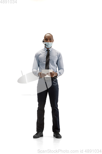 Image of Young african-american call center consultant with headset isolated on white studio background