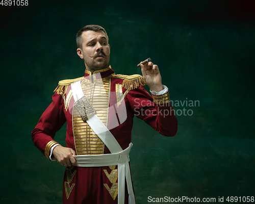 Image of Young man as Nicholas II on dark green background. Retro style, comparison of eras concept.