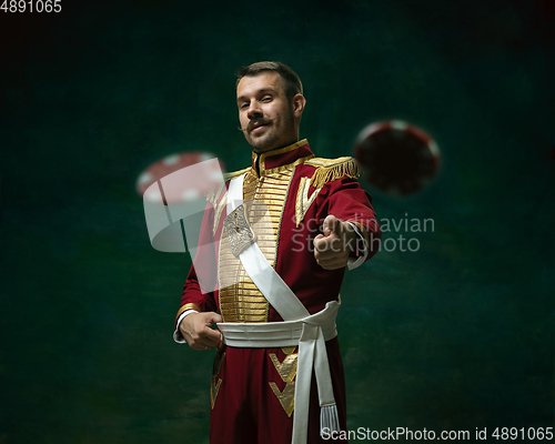 Image of Young man as Nicholas II on dark green background. Retro style, comparison of eras concept.