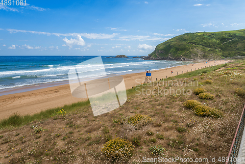 Image of View to the Zarautz Beach with walking people, Basque Country, Spain on a beautiful summer day