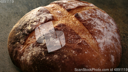 Image of Freshly baked natural bread is on the kitchen table.