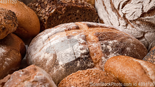 Image of Freshly baked natural bread is on the kitchen table.