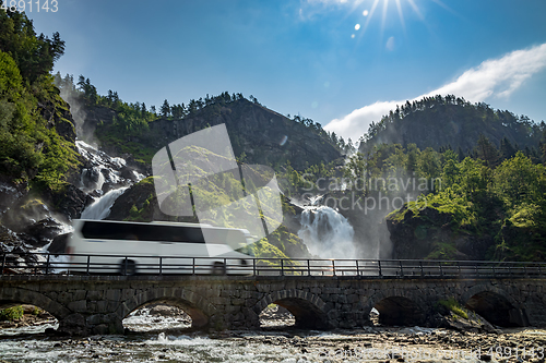 Image of Tourist bus traveling on the road Latefossen Waterfall Odda Norw