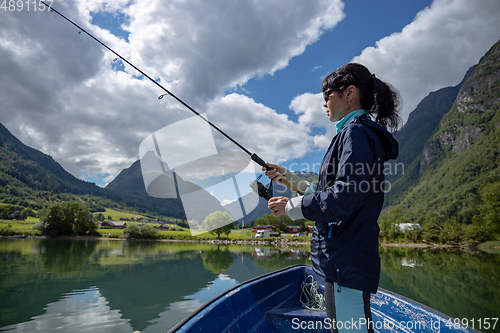 Image of Woman fishing on Fishing rod spinning in Norway.