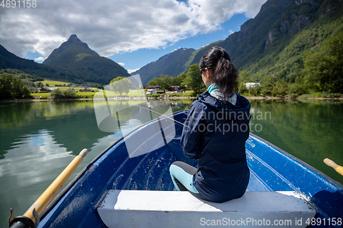 Image of Woman fishing on Fishing rod spinning in Norway.