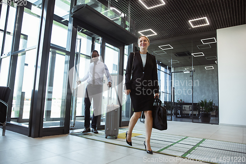 Image of Meeting of young business partners after arriving to end point of business trip