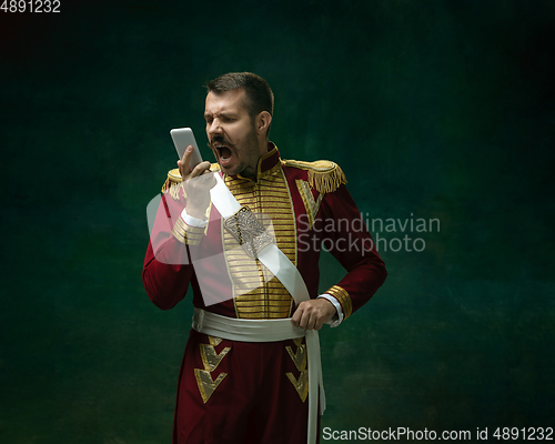 Image of Young man as Nicholas II on dark green background. Retro style, comparison of eras concept.