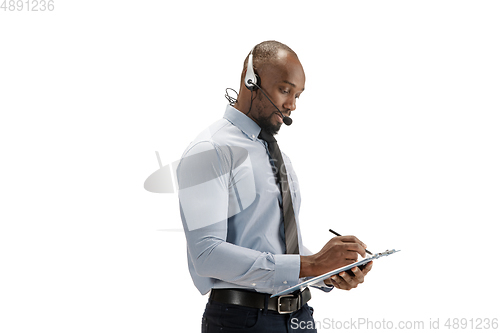 Image of Young african-american call center consultant with headset isolated on white studio background