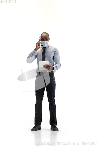 Image of Young african-american call center consultant with headset isolated on white studio background