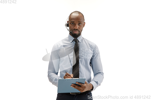 Image of Young african-american call center consultant with headset isolated on white studio background