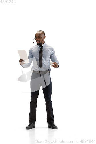 Image of Young african-american call center consultant with headset isolated on white studio background