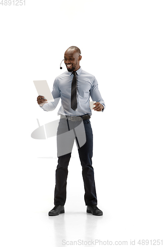 Image of Young african-american call center consultant with headset isolated on white studio background