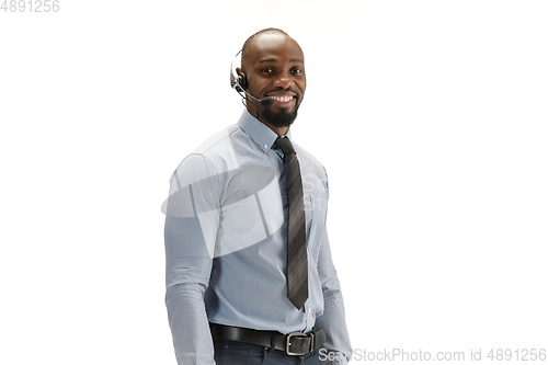 Image of Young african-american call center consultant with headset isolated on white studio background