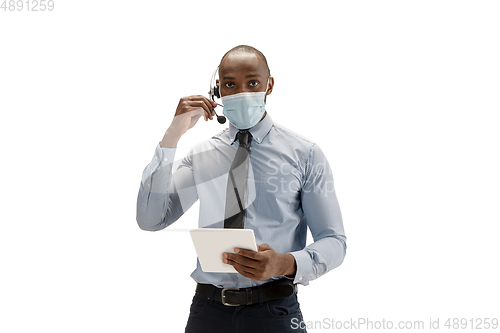 Image of Young african-american call center consultant with headset isolated on white studio background