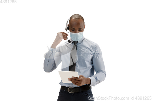 Image of Young african-american call center consultant with headset isolated on white studio background