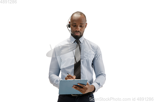 Image of Young african-american call center consultant with headset isolated on white studio background