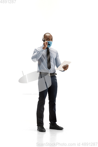 Image of Young african-american call center consultant with headset isolated on white studio background