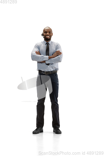 Image of Young african-american call center consultant with headset isolated on white studio background