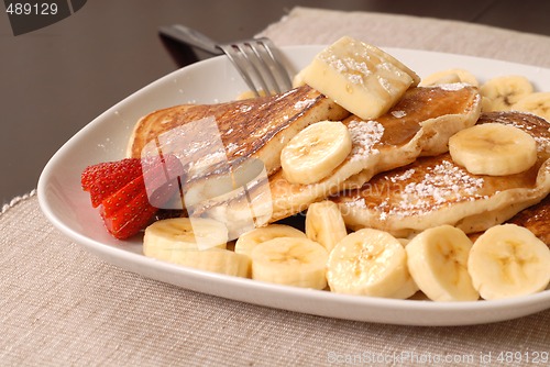 Image of Banana pancakes with maple syrup and a fork