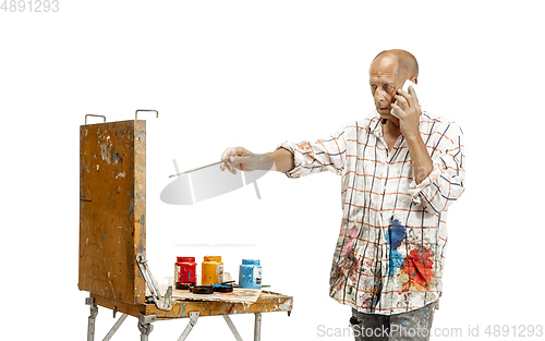 Image of Artist, painter at work isolated on white studio background
