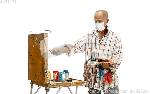 Image of Artist, painter at work isolated on white studio background