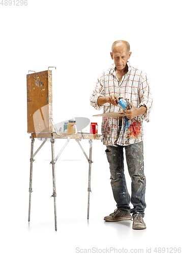 Image of Artist, painter at work isolated on white studio background