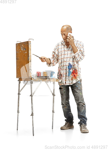 Image of Artist, painter at work isolated on white studio background