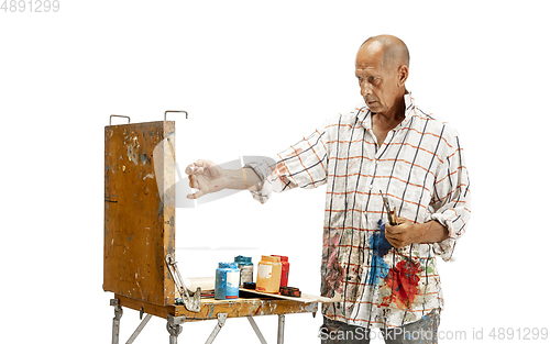 Image of Artist, painter at work isolated on white studio background