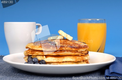 Image of Blueberry pancakes with coffee and orange juice