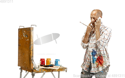 Image of Artist, painter at work isolated on white studio background