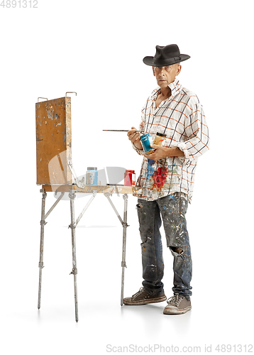 Image of Artist, painter at work isolated on white studio background