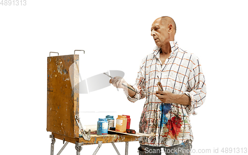 Image of Artist, painter at work isolated on white studio background