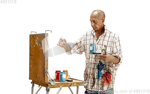 Image of Artist, painter at work isolated on white studio background