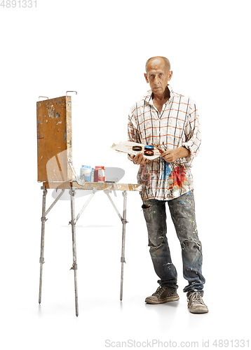 Image of Artist, painter at work isolated on white studio background