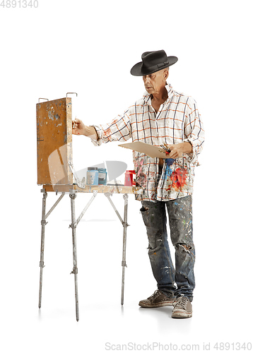 Image of Artist, painter at work isolated on white studio background