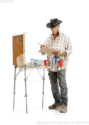 Image of Artist, painter at work isolated on white studio background