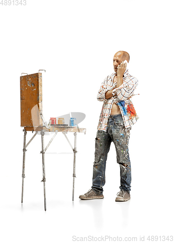 Image of Artist, painter at work isolated on white studio background