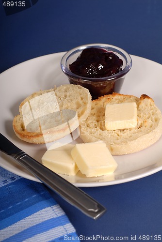 Image of English muffin with butter and jam