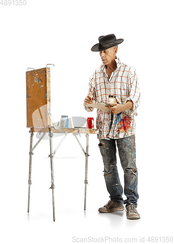 Image of Artist, painter at work isolated on white studio background