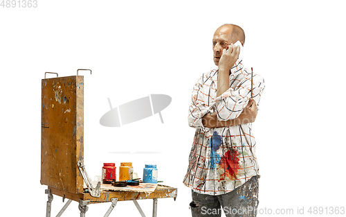 Image of Artist, painter at work isolated on white studio background