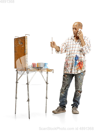 Image of Artist, painter at work isolated on white studio background