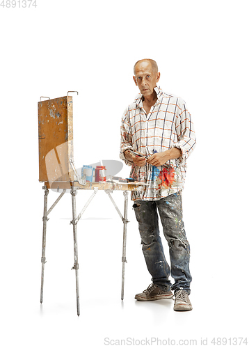 Image of Artist, painter at work isolated on white studio background