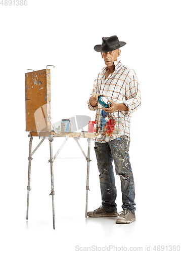 Image of Artist, painter at work isolated on white studio background