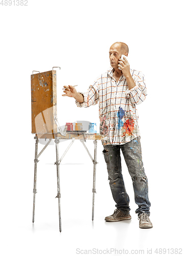 Image of Artist, painter at work isolated on white studio background