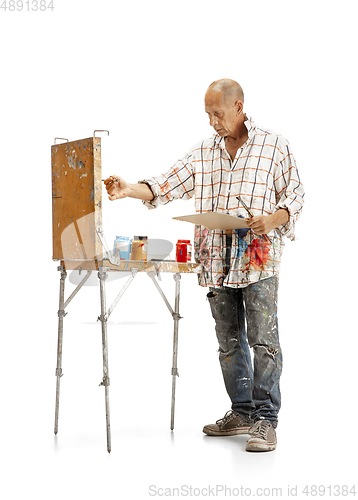 Image of Artist, painter at work isolated on white studio background