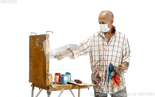 Image of Artist, painter at work isolated on white studio background