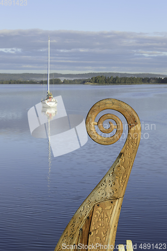 Image of A modern sailboat and a vikingskip
