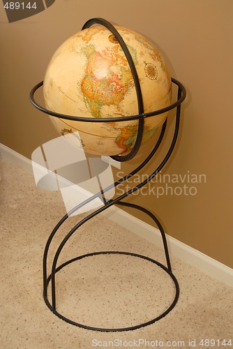 Image of Antique world globe on iron stand