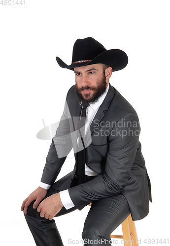 Image of A portrait image of a man in a suit and cowboy hat