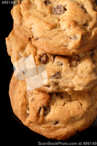 Image of Closeup of three chocolate chip cookies verticle view